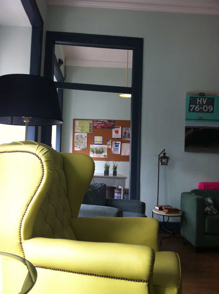 Beautiful upholstered leather chairs in the common room of the hostel